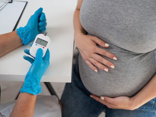 Pregnant woman getting glucose test at doctor's office