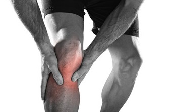 Man holding knee in pain