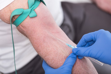 Healthcare professional inserting an IV catheter