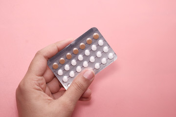 woman holding a packet of birth control pills