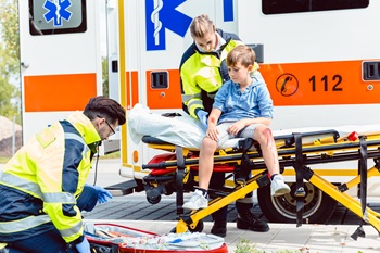 Paramedics tending to child with wounds