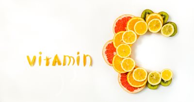 word Vitamin C spelled in citrus fruits