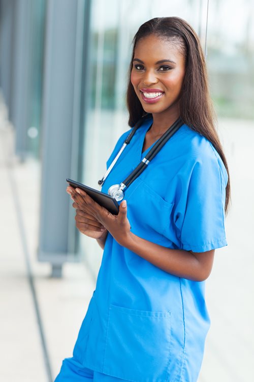 A nurse on a computer.