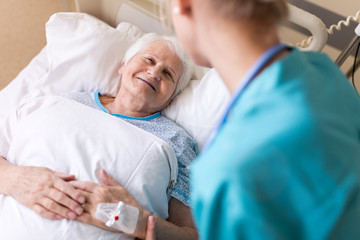 Nurse caring for elderly female patient
