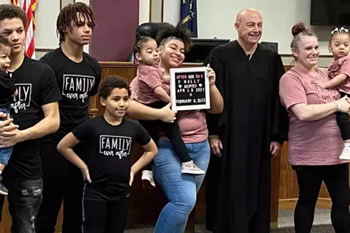 image of nurse and adopted family in courtroom
