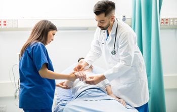 Nurse and Doctor examining patient in ER.