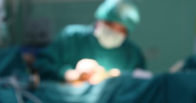 a blurred image of a doctor performing surgery
