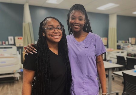 2 teenagers in a nursing sim lab