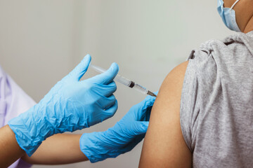 Nurse giving patient a shot in the arm.