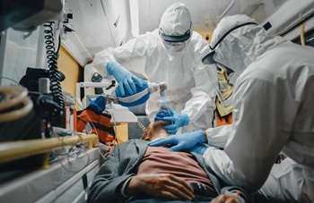 EMS in hazmat suits caring for patient