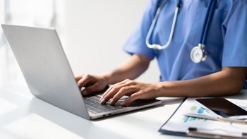 nurse aide working at computer