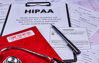 hospital paperwork on a clip board with HIPAA written across it. 