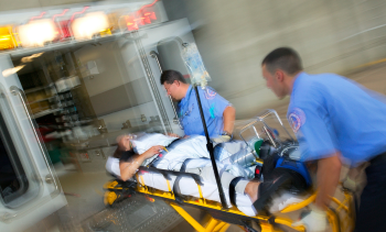 EMS rushing patient into ambulance