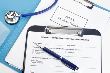 HIPAA regulations document with an authorization for release of health information form and pen