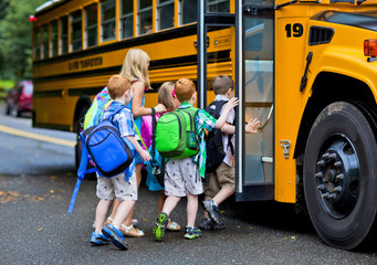 kids getting on a school bus