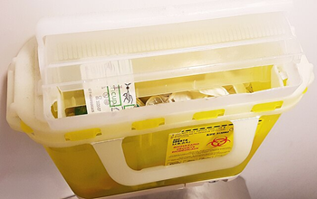 Yellow sharps container, overfilled
