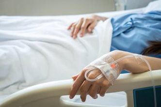 Patient lying in a hospital bed. 