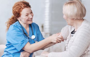Nurse pushing up a patients sleeve to take a blood pressure. 