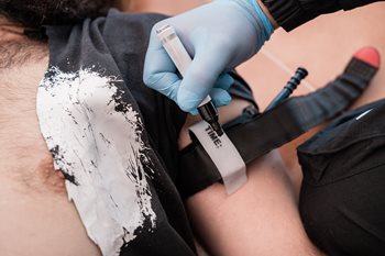 EMT applying tourniquet to patient's arm