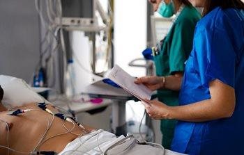 Nurses taking 12 lead EKG on patient