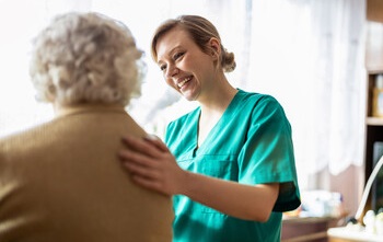 Nurse with elderly patient in a long term care facility. 