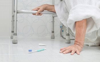 Patient on the bathroom floor with dropped toothbrush. 