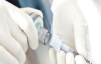 nurse connecting tube at the bedside
