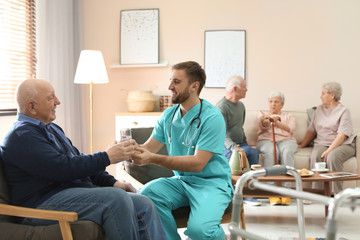 Male nurse handing male patient antibiotics
