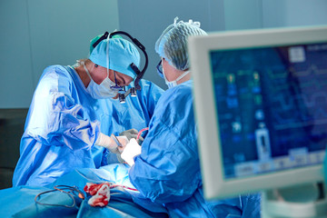 Surgeons performing open heart surgery.