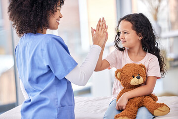 Nurse high fiving pediatric patient