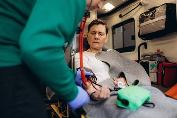 EMS performing a physical examination of a patient