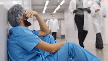 burned out nurse sitting on the floor