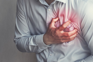 man clutching his chest