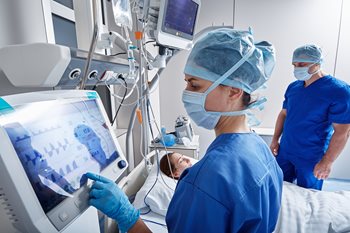 nurse at ICU patient bedside