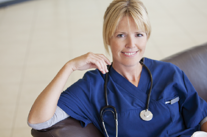 Female nurse with stethoscope smiling