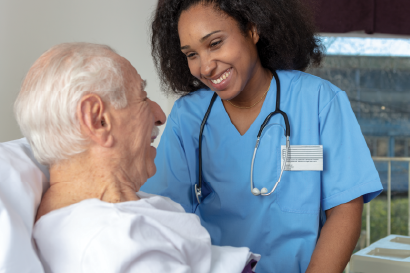 Nurse aide helping a patient.